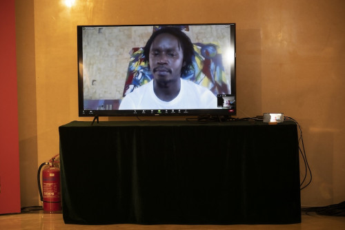 Artist José Estevão Manhiça gives a brief presentation on his exhibition, via videoconference