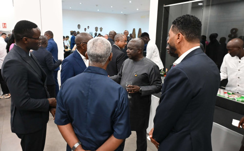 Guests discuss and exchange at the reception.